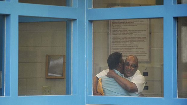 Andre Davis, right, is hugs his father Richard Davis inside the Tamms Correctional Centre.