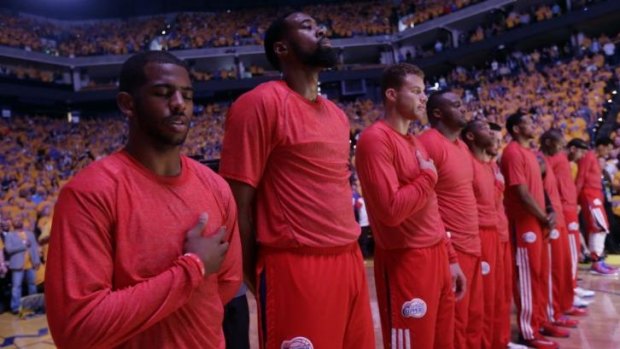 Seeing red: The LA Clippers stage their protest before game four against Golden State.