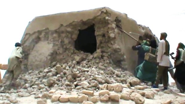 A still from a video shows Islamist militants destroying an ancient shrine in Timbuktu on July 1.
