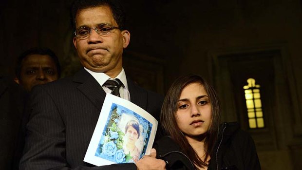 Shattered: Lisha Barboza, with her father Ben as he holds a photograph of his wife Jacintha Saldanha.