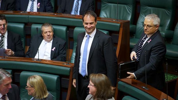 Whack! ... Frankston MP Geoff Shaw leaves Parliment yesterday.