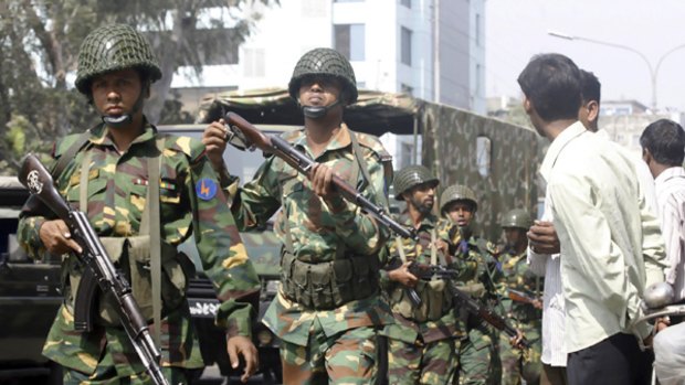 Army soldiers walk towards the headquarters of the paramilitary Bangladesh Rifles (BDR) in Dhaka.