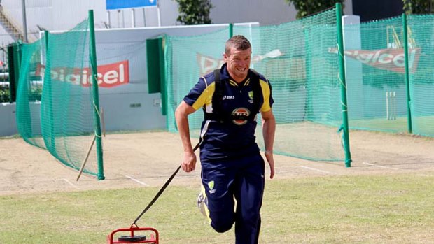 Peter Siddle warms up in Barbados yesterday.