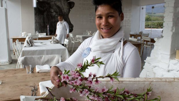 Organic oasis: a waitress brings in fresh blossoms for the tables at Babel Restaurant.