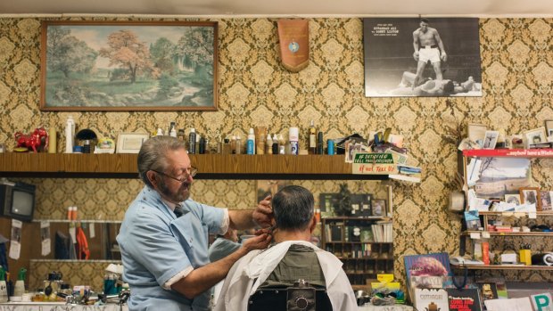 Barber Angelo Perri keeps busy at Paris Style Hairdresser, which looks like a perfectly preserved time capsule from the mid-1960s,  in Cabramatta.