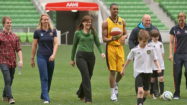 Federal Sports Minister Kate Lundy, centre, next to basketballer Bennie Lewis and other representatives signed up for the Tackling Binge Drinking intiative.