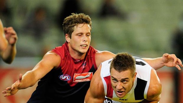 Tackle coming: Melbourne's Rohan Bail gets set to pounce on St Kilda's Sam Fisher last night.