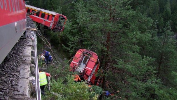 Crash scene: Police and rescue workers help after the Swiss train derailed.