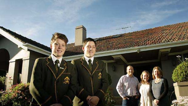 Trinity Grammar School students Alex (left) and Billy Syme, stand before father Tom, Emily and mother Janene Syme, outside their Mont Albert home.
