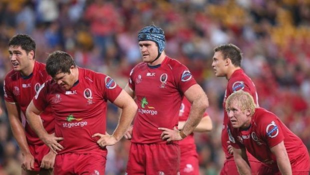 James Horwill and his Reds teammates are dejected after going down to the Rebels.