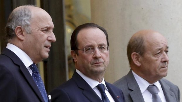 Francois Hollande, centre, with the Foreign Affairs Minister Laurent Fabius, left, and Defence Minister Jean-Yves Le Drian at the Elysee Palace in Paris this week.