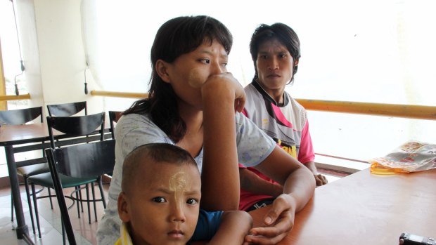 Khine Zin Soe, 24, centre, worked in a shrimp shed when she was pregnant and the owner forced her to work peeling shrimp even when she miscarried. With her are her husband, Kyaw Kyaw Aung, and her son, Htet Wai Yan. 