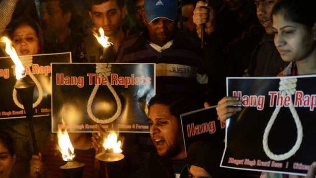 On December 19, 2012 Indian students and activists shout slogans as they carry torches at India Gate during a protest following the gang-rape of a student in New Delhi.