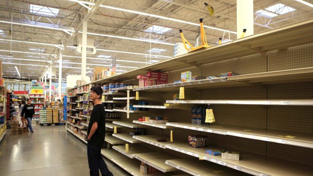 Logan Garcia looks for last-minute supplies at a grocery store in Corpus Christi, Texas.