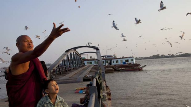Wing and a prayer &#8230; a Burmese monk and his son feed seagulls from a jetty on the Rangoon River.