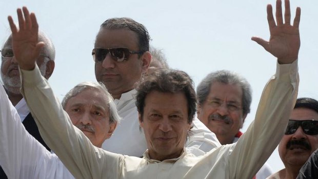 Pakistan cricketer-turned-politician Imran Khan greets supporters as he leads the protest march from Lahore to Islamabad.