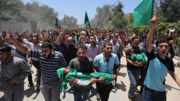 Palestinians carry the body of three-year-old Mohammed Mnassrah during his funeral.