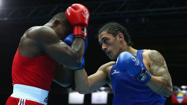 Turning professional: Australian boxer Jai Opetaia (blue) competes at the Commonwealth Games in Glasgow in July.