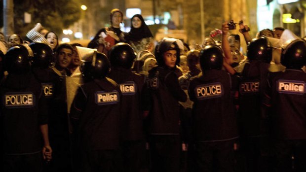 Protest ... Egyptian riot police stand guard.