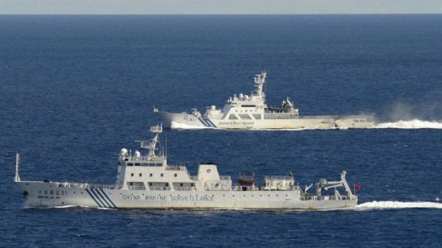 Chinese marine surveillance ship Haijian No. 51 (front) cruising as a Japan Coast Guard ship sails near the disputed islands, called Senkaku in Japan and Diaoyu in China.