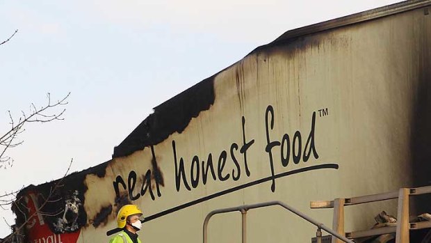 A fireman passes a burnt out lorry at the scene, near Taunton.