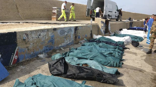 Overwhelmed: Bodies of the drowned migrants are lined up in the port of Lampedusa.
