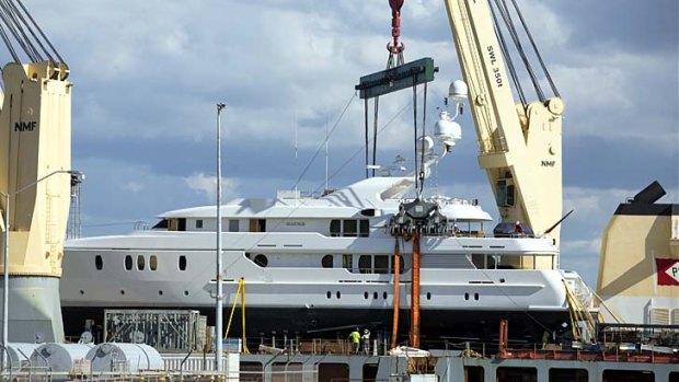 Pleasure cruiser: James Packer's new water toy arrives in Darwin Harbour on the back of a larger boat.