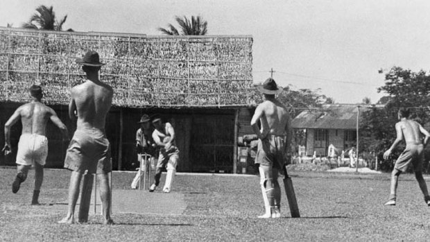 Australian soldiers playing cricket on an improvised wicket in Malaya, 1941.