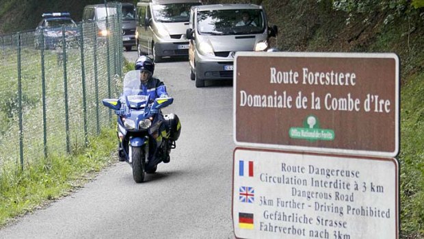 Tragedy: French gendarmes escort hearses from the scene last September.