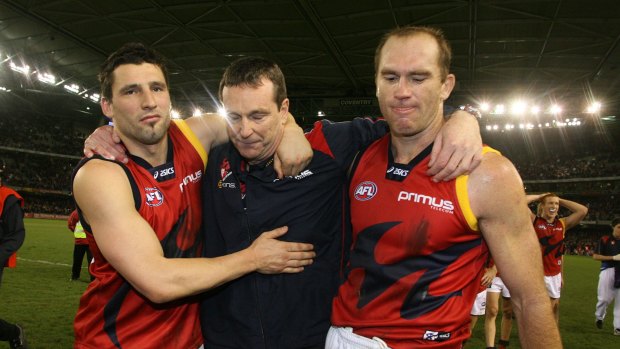 Russell Robertson, Neale Daniher and David Neitz leave the field overcome with emotion after Daniher's last game as Melbourne coach in 2007. 