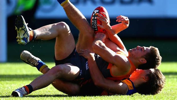 Get a grip ... Giant Stephen Coniglio is tackled by Eagle Andrew Gaff.