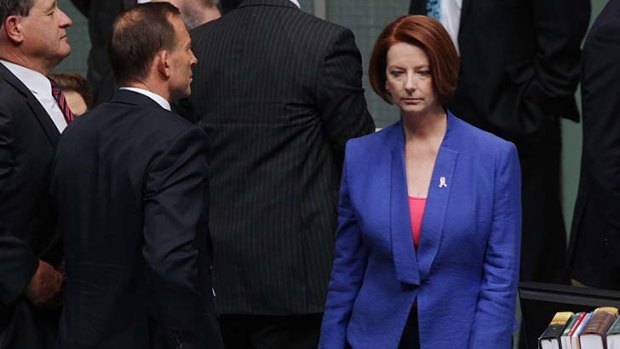 Political rivals ... Julia Gillard walks past Tony Abbott.