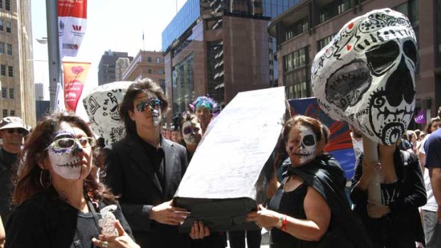 Protesters in the Occupy Sydney march carry a coffin during today's rally.