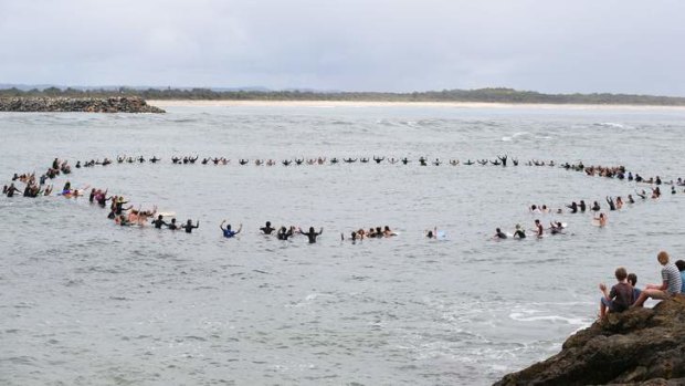 Zac Young's friends form a circle off Port Macquarie's Town Beach to remember him.