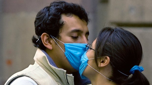 On alert ... a couple wearing masks kiss in Mexico City.