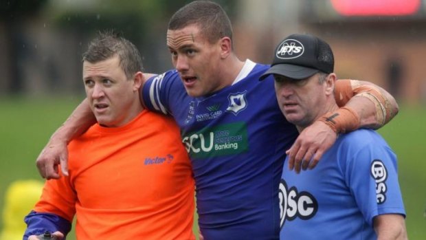 Blessing in disguise: Kane Evans helped off the field after injuring himself in a Newtown Jets game. 