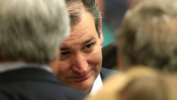 Republican presidential candidate, Senator Ted Cruz, listens to supporters at a caucus site.