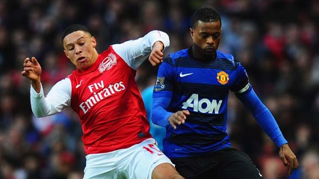 Star of the future ... Alex Oxlade-Chamberlain of Arsenal (R) battles with Patrice Evra of Manchester United.