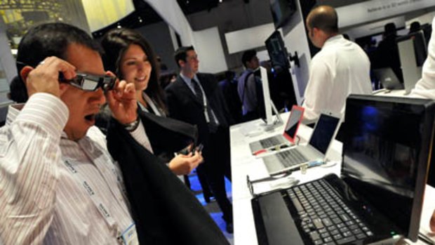 CES antendees Israel Juarez (L) and Monica Calzado view Sony's Vaio F Series Laptop 3D Multimedia PC at Sony's booth at the 2011 International Consumer Electronics Show.