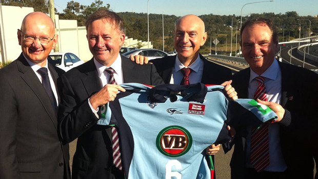 Member for Blair Shayne Neumann, Member for Oxley Bernie Ripoll and Ipswich Mayor Paul Pisasale present rugby league fan and Federal Transport Minister Anthony Albanese with a Blues jersey.