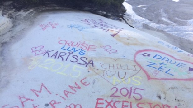 Visitors have been making their mark by chalking names on the rock in bright colours.