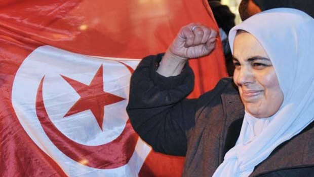 A Tunisian woman celebrates after the announcement that Zine El Abidine Ben Ali has quit as president and fled to Saudi Arabia.