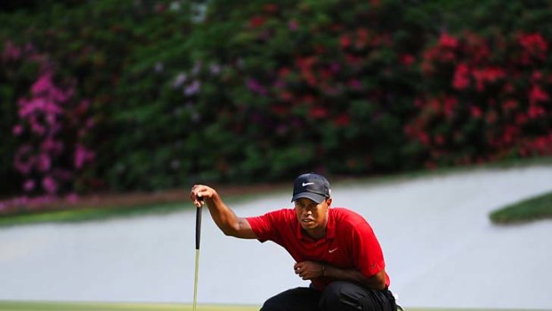 Tiger Woods lines up a putt on the 13th hole.