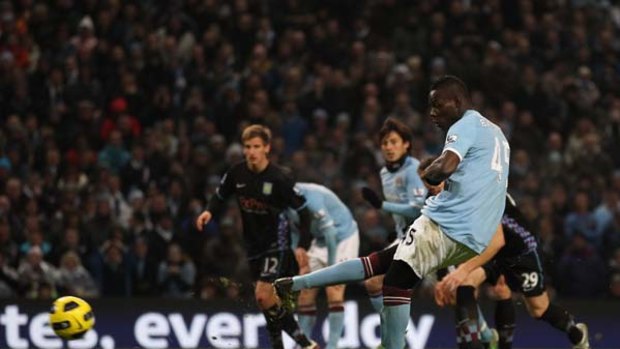 Mario Balotelli of Manchester City scores his third goal from the penalty spot.