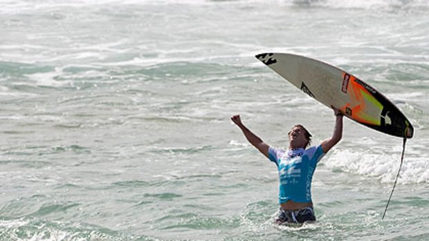 Taj Burrow celebrates after his win at the Pipeline Masters in Hawaii.