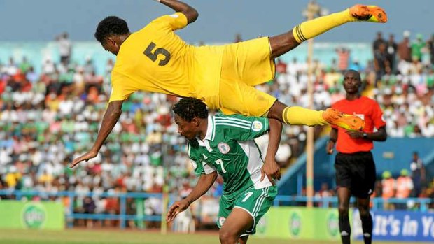 Ethiopia midfielder Hajlu Aynalem jumps on Nigerian striker Ahmed Musa.