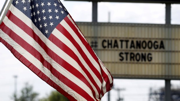 A US flag flies alongside a sign in honour of the four Marines killed in Chattanooga, Tennessee, on Thursday.