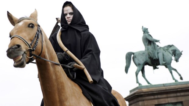 A woman dressed as Death, of the Four Horsemen of the Apocalypse at a Greenpeace demonstration in Copenhagen.