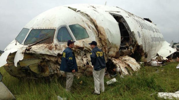 The National Transportation Safety Board shows investigators near the remains of a UPS cargo plane that crashed Wednesday in a grassy area outside an airport in Birmingham, Alabama.