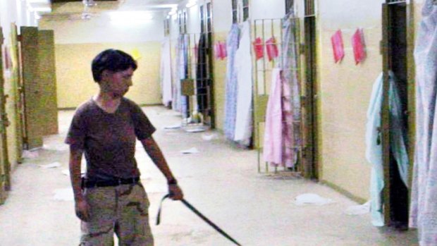 Lynndie England holding a leash connected to a naked detainee at the Abu Ghraib prison in Baghdad.